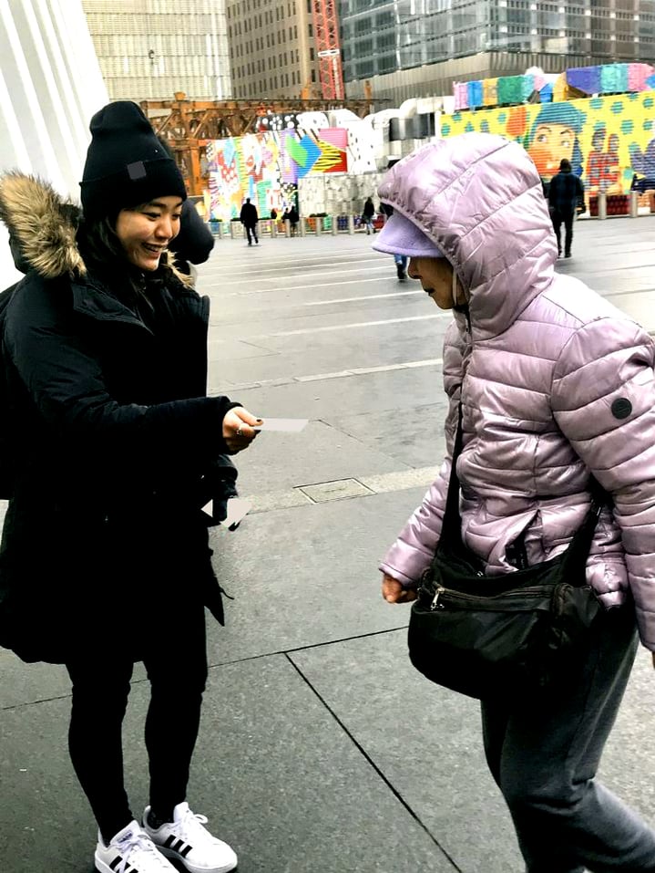 band ambassador handing out a sample to pedestrian in nyc