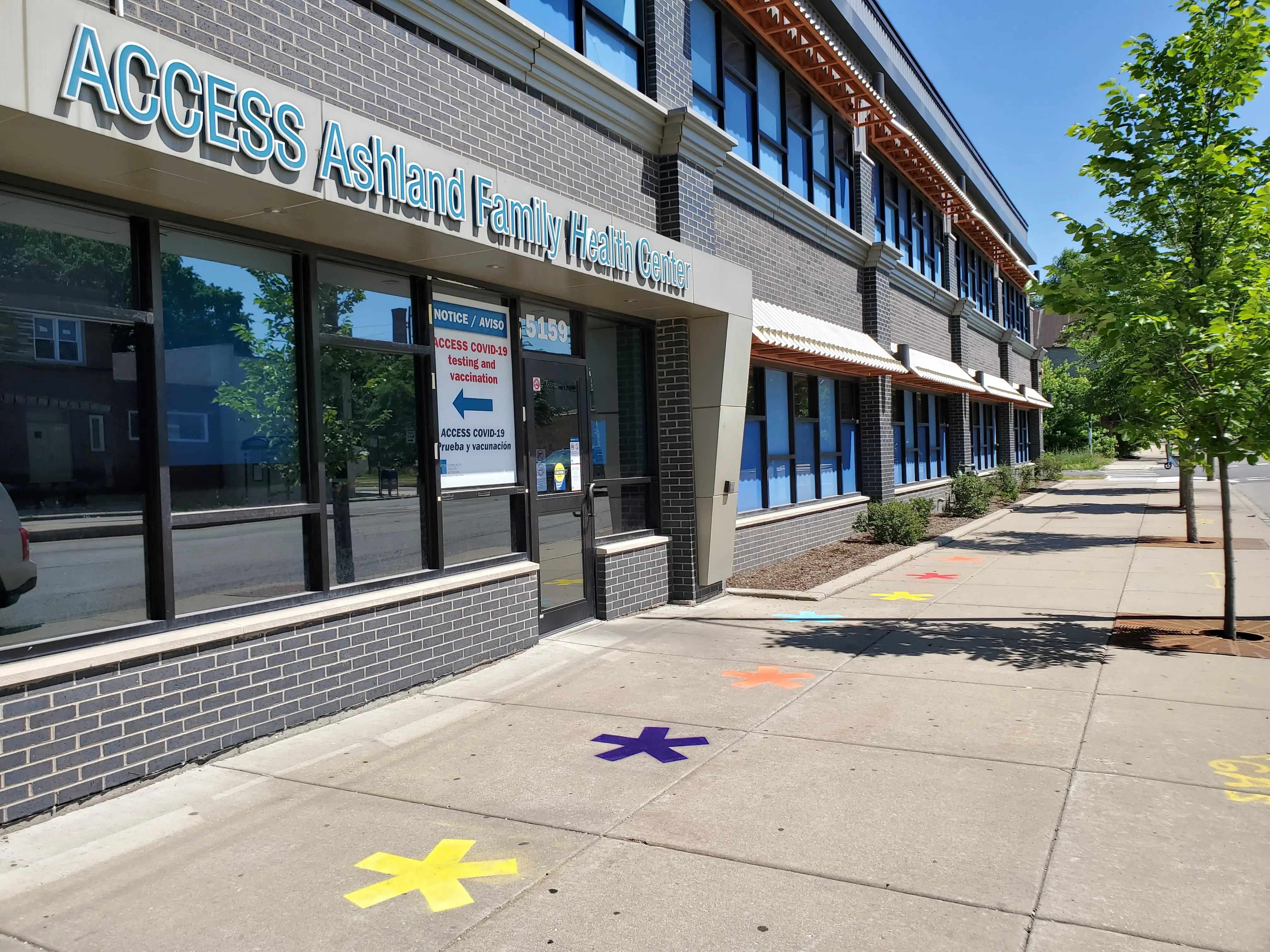 Chalk stencil advertisement outside a Health Center