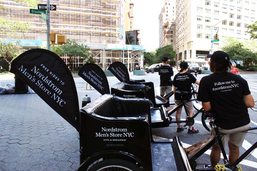 Branded black and white Nordstrom pedicabs on Broadway in Manhattan