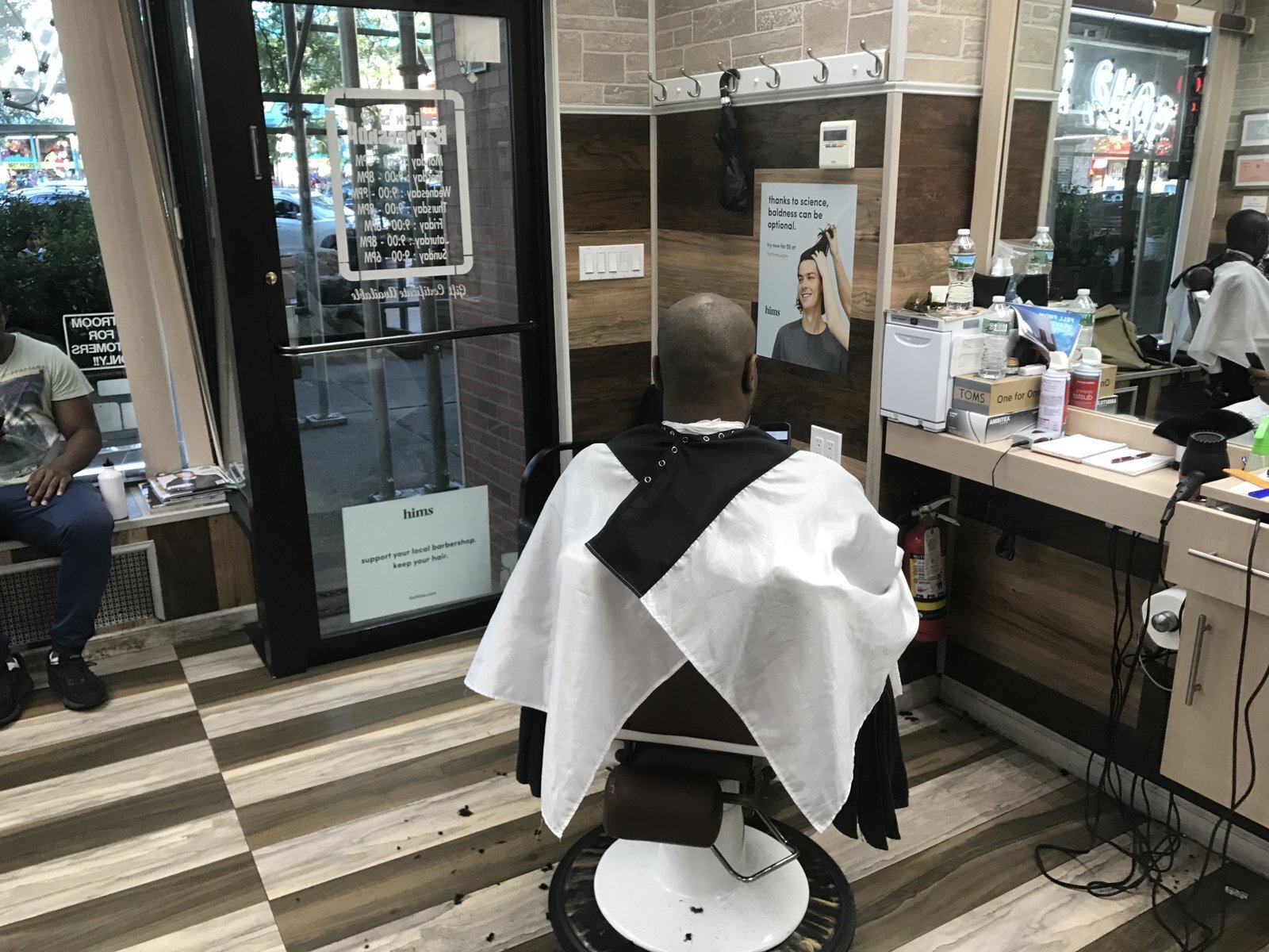 Hims poster placement inside a barbershop