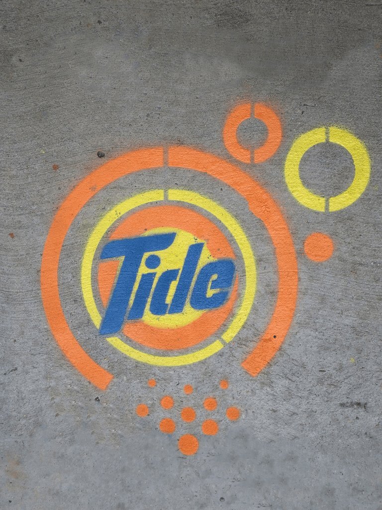 Tide chalk stencil on a sidewalk